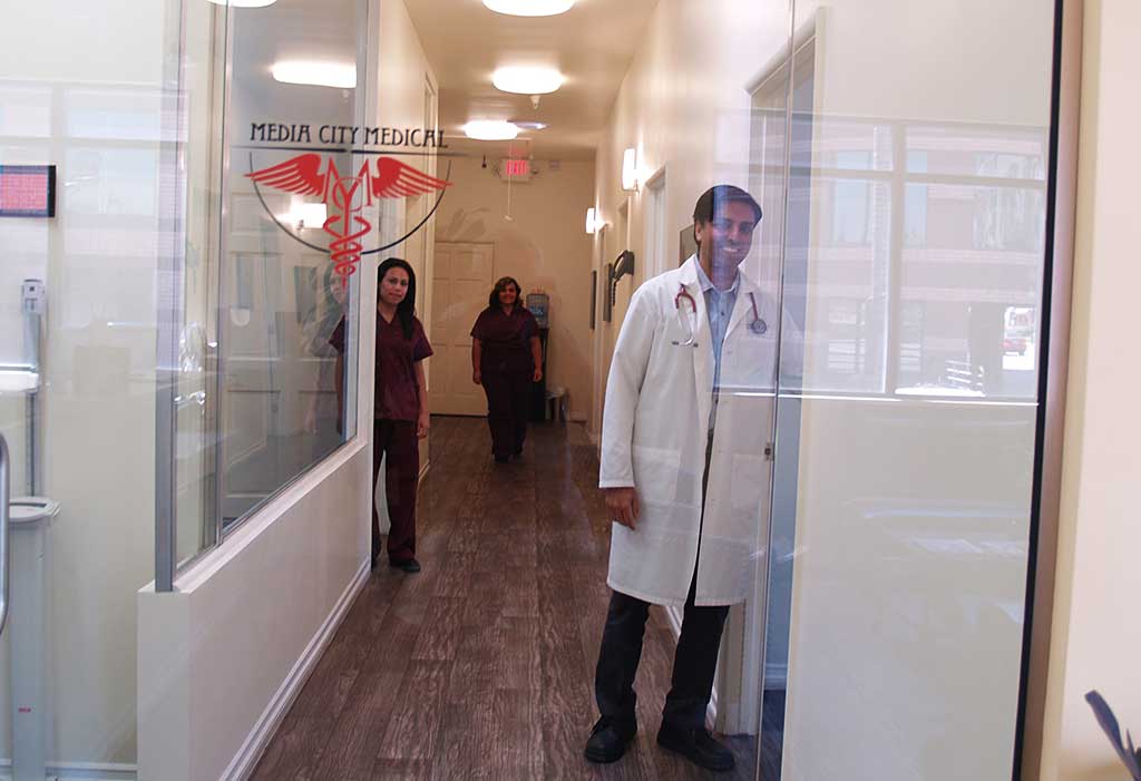 Paresh N. Varu, MD standing in the office hallway with his nurses.